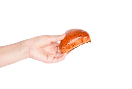Fresh bun in his hand isolated on white background