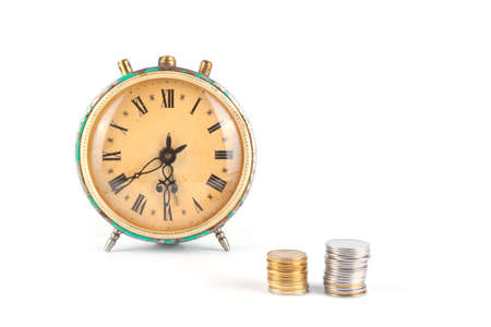 Old clock and coins on a white background. Concept of savings. Deposit