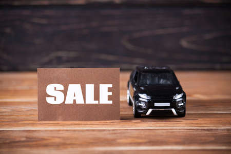 The little machine with inscription sale on the wooden boards. car agent sale conceptの写真素材