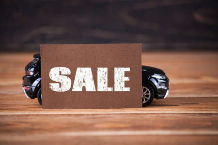The little machine with inscription sale on the wooden boards. car agent sale conceptの写真素材