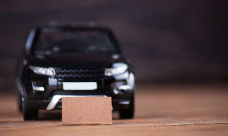 The little machine with the card for an inscription on the wooden boards. car agent sale concept