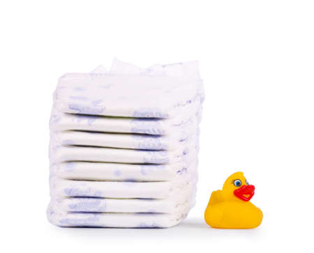 Disposable diapers and the rubber duckling, isolated on white backgroundの写真素材