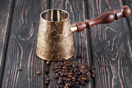 Empty copper coated turk isolated on wood backgroundの写真素材