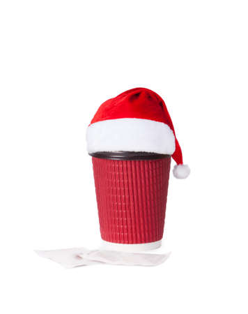 disposable cup in santa hat  of coffee isolated on white backgroundの写真素材