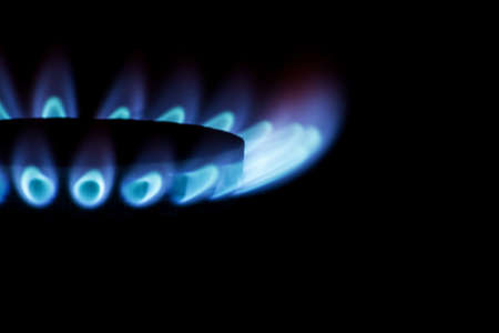 Gas burner with blue flames on black backgroundの写真素材