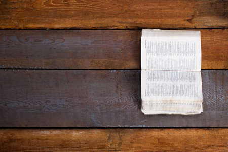 Open Bible on wooden boards.の写真素材