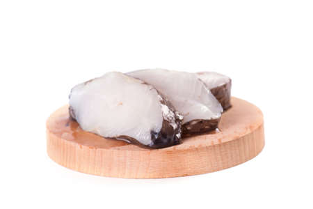 Marine fish on the kitchen board isolated on white backgroundの写真素材