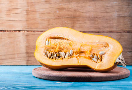 Ripe cut pumpkin on wood desk.の写真素材