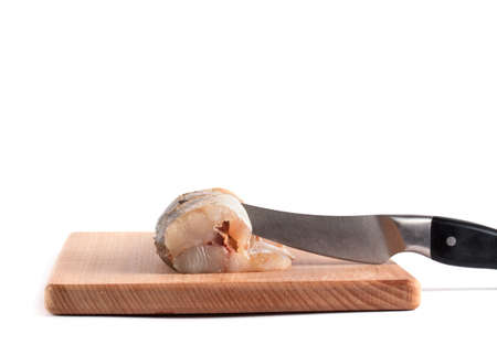 Fresh pike on a wooden chopping board isolated on white backgroundの写真素材