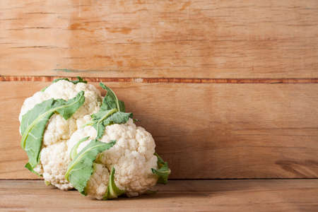 Fresh ripe cauliflower isolated on wood background.の写真素材