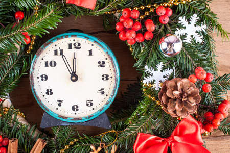 Christmas wreath and clock clothe up. Greeting card. Christmas backgroundの写真素材