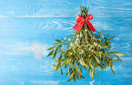 Broom from green mistletoe on wood desk. Nature background. Christmas plantの写真素材