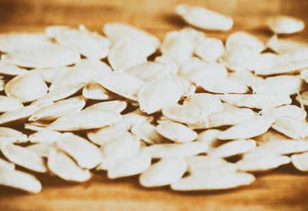 Pumpkin  seeds close up on wood desk. Food backgroundの写真素材