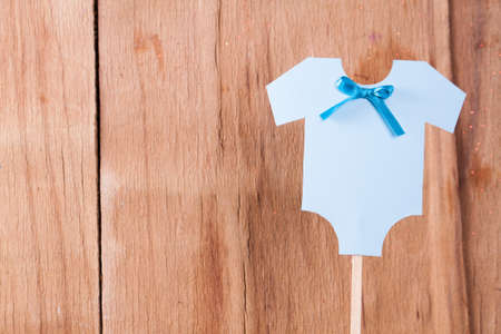 Decoration for Baby shower on wood desk. Color garland from infant shirt. Gift boxの写真素材