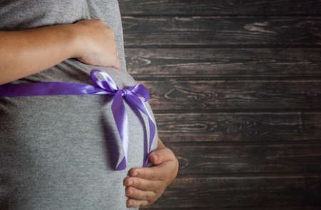 Image of pregnant woman touching her belly with handsの写真素材