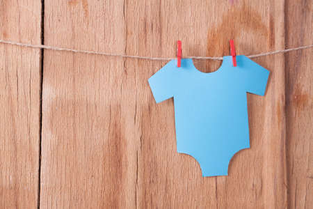 Decoration for Baby shower on wood desk. Color garland from infant shirt. Gift boxの写真素材