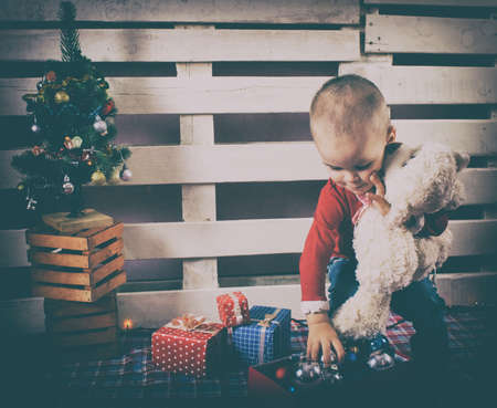 Retro photo. Children in Christmas clothes and santa hat. Christmas decoration.の写真素材