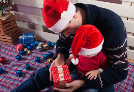 Children in Christmas clothes with gift box. Christmas backgroundの写真素材