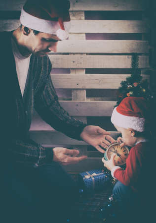 Dad with son decorate Christmas tree. Christmas backgroundの写真素材