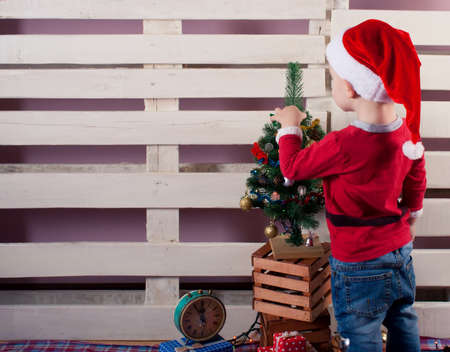 Children in Christmas clothes and santa hat. Christmas decoration.の写真素材