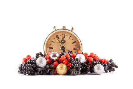 Ripe red and black rowan isolated on white background. Clock and christmas ballの写真素材
