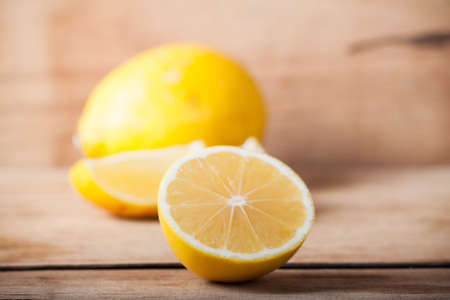 Ripe fresh lemon on wood desk. Food ingredient. Nature background