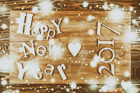 Wood inscription Happy New Year on wood board. Greeting card
