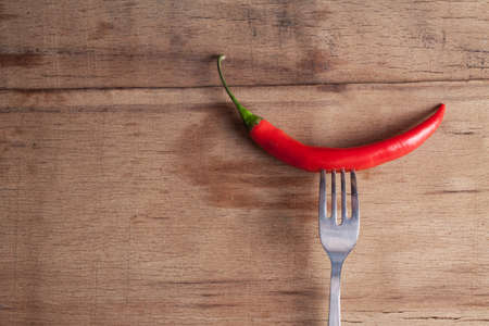 Red fresh chili on wood desk. Food background. Cookingの写真素材