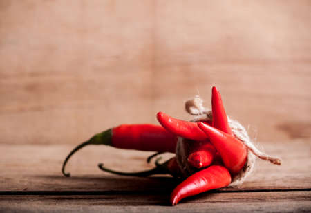 Red fresh chili on wood desk. Food background. Cookingの写真素材