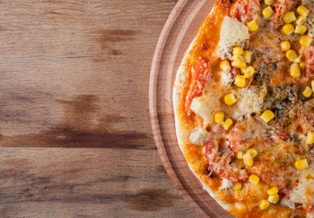 Fresh pizza with cheese on wood desk. Food backgroundの写真素材