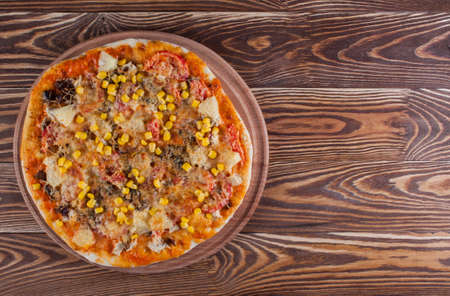 Fresh pizza with cheese on wood desk. Food backgroundの写真素材