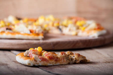 Fresh pizza with cheese on wood desk. Food backgroundの写真素材