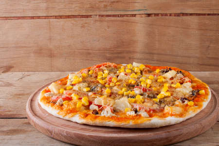 Fresh pizza with cheese on wood desk. Food backgroundの写真素材