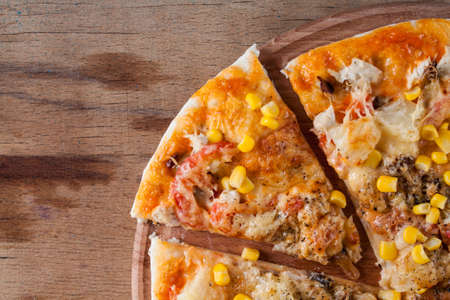 Fresh pizza with cheese on wood desk. Food backgroundの写真素材