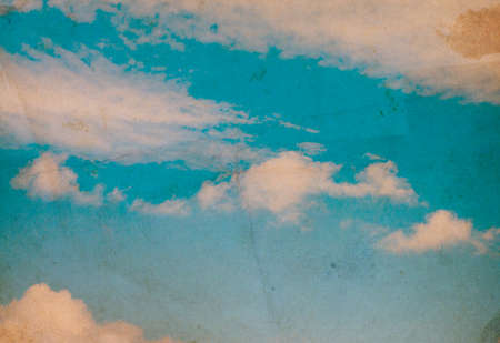 Retro photo with noisy texture. Blue sky with clouds.の写真素材