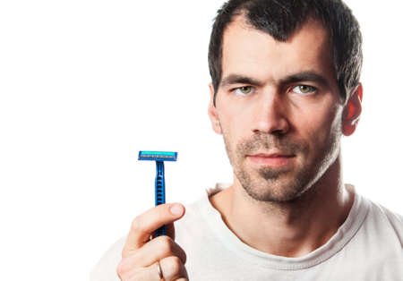 Time for new razor. Close-up young shirtless man holding razorの写真素材