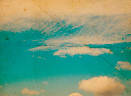 Retro photo with noisy texture. Blue sky with clouds.の写真素材