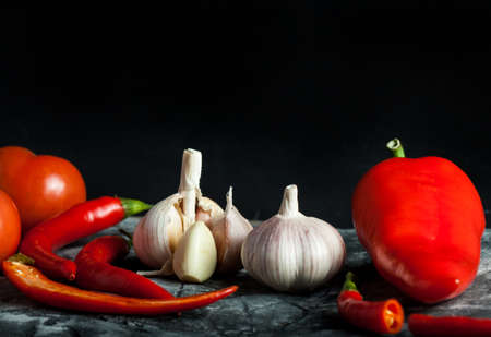 Garlic, chili and red pepper on scratched background. Food ingredientの写真素材