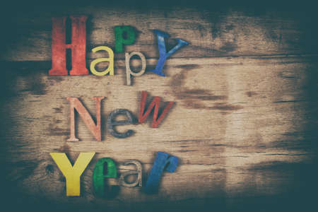 Multicolor wood inscription Happy New Year close up. Greeting card