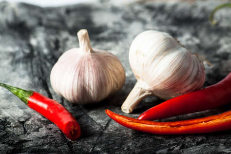 Garlic and chili on scratched background. Food ingredients. Nature backgroundの写真素材
