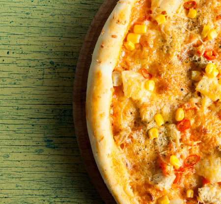 Fresh pizza with cheese on wood desk. Food background.の写真素材