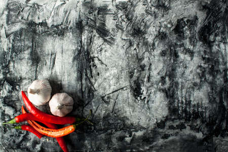 Garlic and chili on scratched background. Food ingredients. Nature backgroundの写真素材