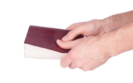 Male hand holding a book isolated on a white background