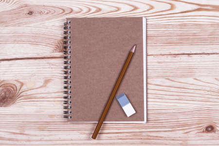 Notebook and pencil on wooden boards. Office objectの写真素材
