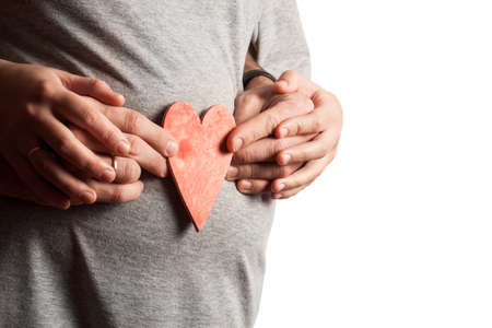 Image of pregnant woman touching her belly with hands on white backgroundの写真素材