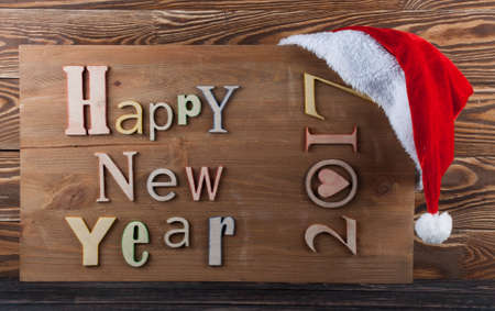 Multicolor wood inscription Happy New Year close up. Greeting card