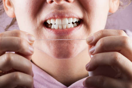 New dental floss on the background of the person. Dental careの写真素材