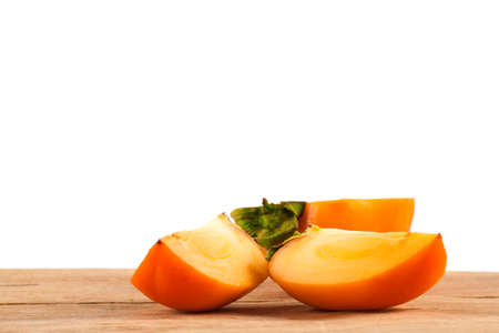 Ripe fresh persimmon isolated on white background. Food ingredient. Fruits.