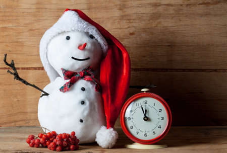 Snowman on wood desk. Greeting card. Christmas background.