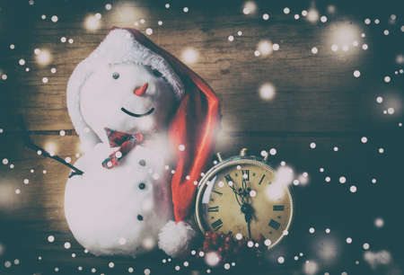 Snowman on wood desk. Greeting card. Christmas background.